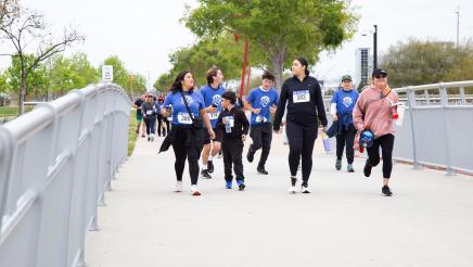 Participants passing over bridge
