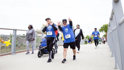 Happy participants passing over bridge