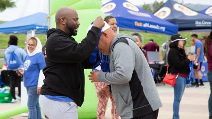 Asm. Gipson presenting medal to participant