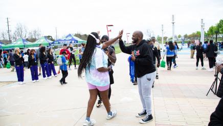 Asm. Gipson congratulating participant finishing race