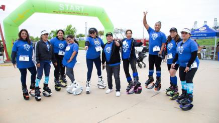 Group of participants in front of starting line inflatable arch