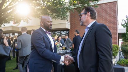 Asm. Gipson shaking hands with an attendee