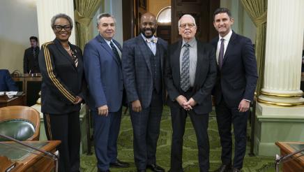 Asm. Gipson with John Baackes and other members on the Assembly Floor