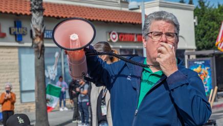 Official speaking into megaphone