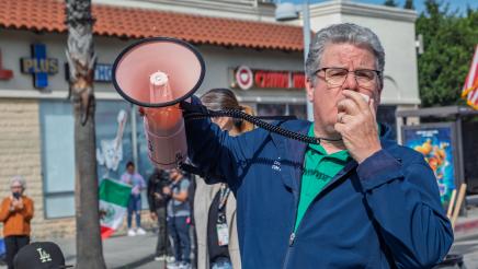 Official speaking into megaphone