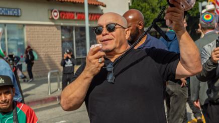Marcher speaking into megaphone
