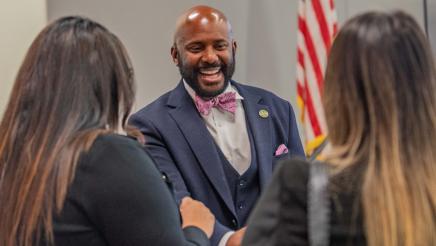 Asm. Gipson greeting two attendees