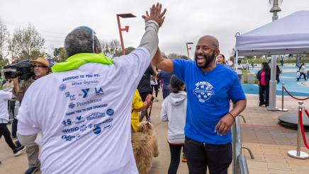 Asm. Gipson doing high five with run participant