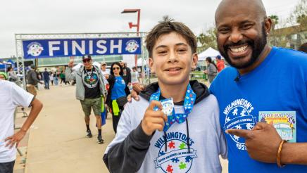 Asm. Gipson congratulating run participant