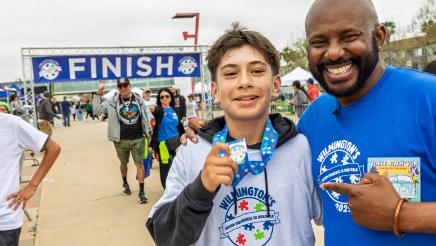 Asm. Gipson congratulating run participant