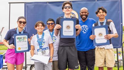 Asm. Gipson with run participants holding awards