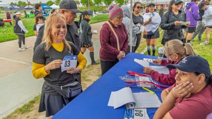 Run participants checking in at welcome table