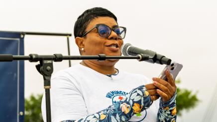 Guest speaker onstage, speaking into microphone