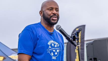 Asm. Gipson onstage, speaking into microphone