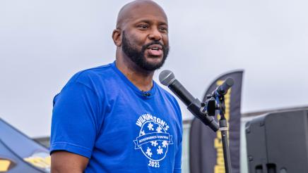 Asm. Gipson onstage, speaking into microphone