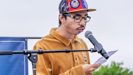 Guest speaker onstage, speaking into microphone