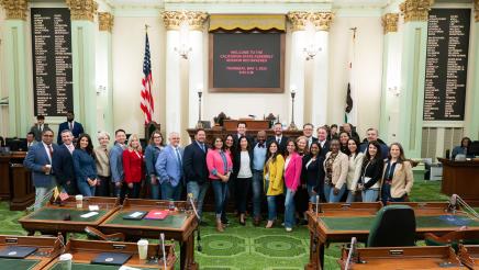 Group photo of Asm. Gipson and other members wearing jeans