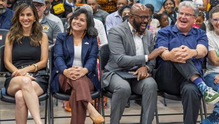 Asm. Gipson sharing a light moment with fellow honoree, with audience in background