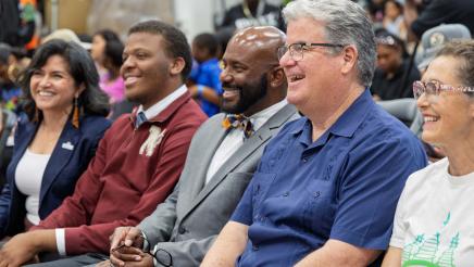 Asm. Gipson and fellow honorees seated, enjoying a light moment