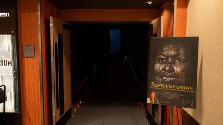 Respect My Crown poster at entrance to movie theater
