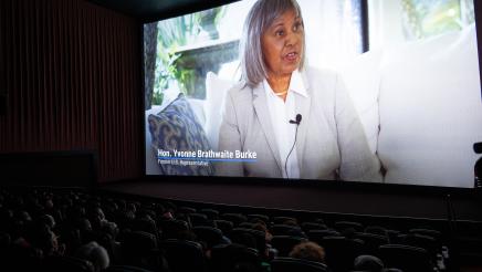 Respect My Crown playing on large screen in movie theater