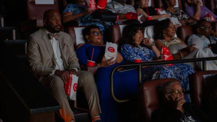 Asm. Gipson and other audience members watching film