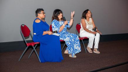 Special guests seated onstage, speaking to audience